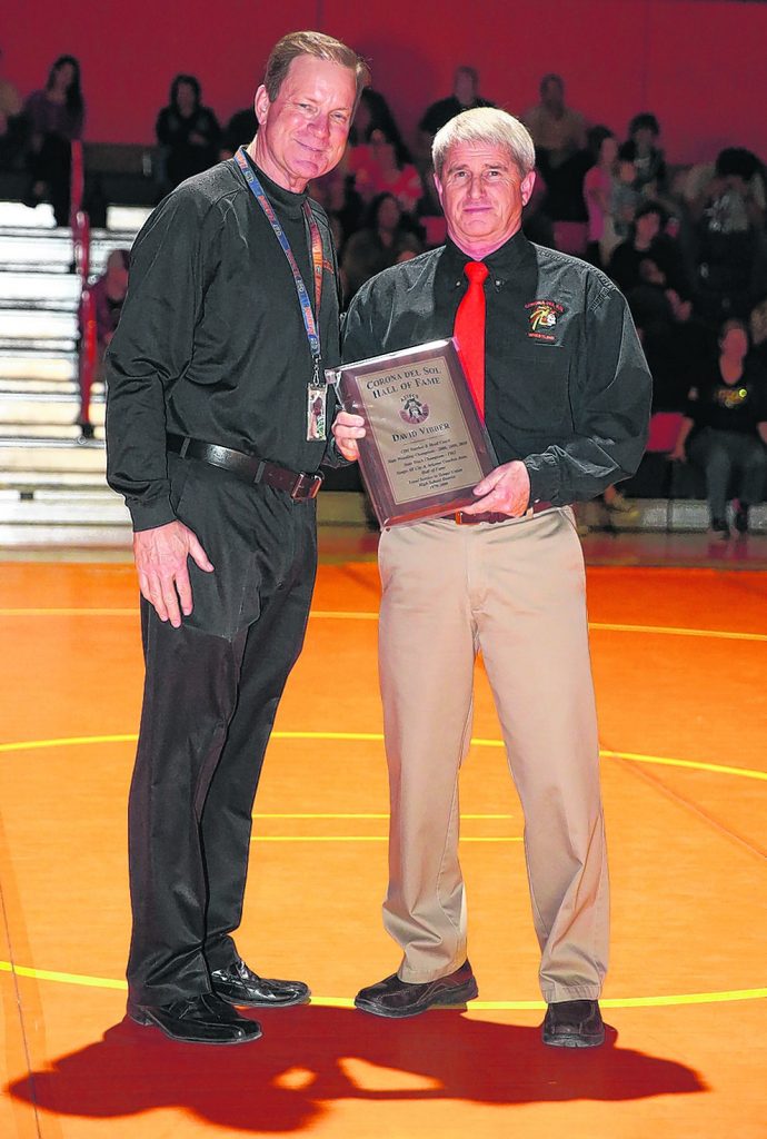 Retired Corona wrestling coach Dave Vibber, right, was inducted into the Aztec Hall of Fame by current athletic director Dan Nero. (Photo by Kris Cartwright for Wrangler News)