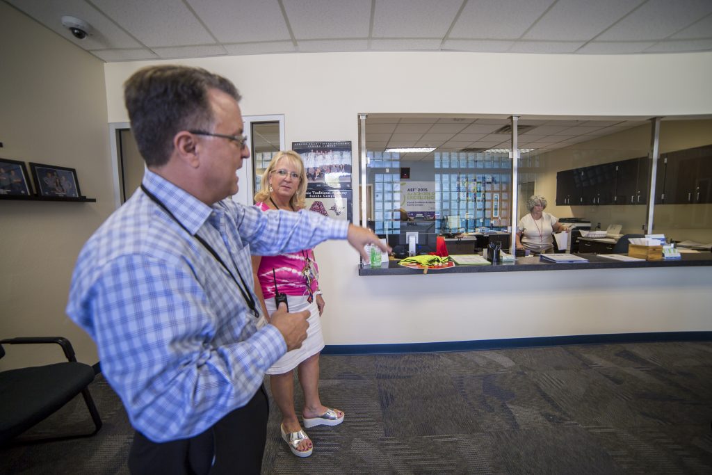 Eric Nethercutt shows KTA principal Dr. Marlanne Lescher newly improved security modifications. 