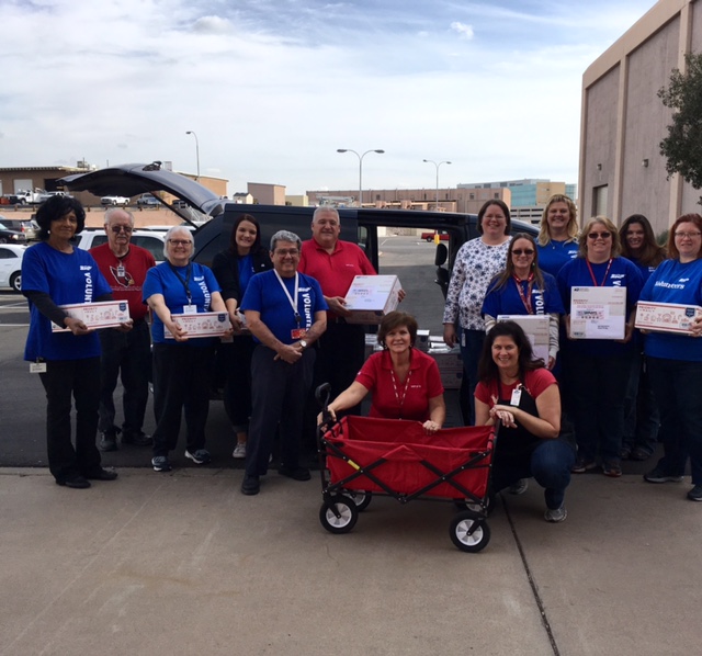 SRP and PCLink employees, friends and family load a van with Cookies for Vets. 