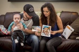 Dad Andy, Mom Elyse and little Jackson look back at how far their baby has come. [Billy Hardiman/Wrangler News]