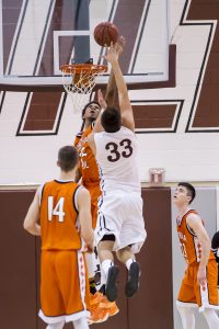 Corona Freshman Marvin Bagley blocks 6'-7" senior James Sosinski's shot at Hamilton. Corona won 69-48. [Photo Billy Hardiman/Wrangler News]