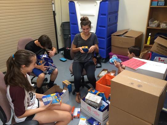 Volunteers and students at Kyrene de los Niños School sort through donations. 